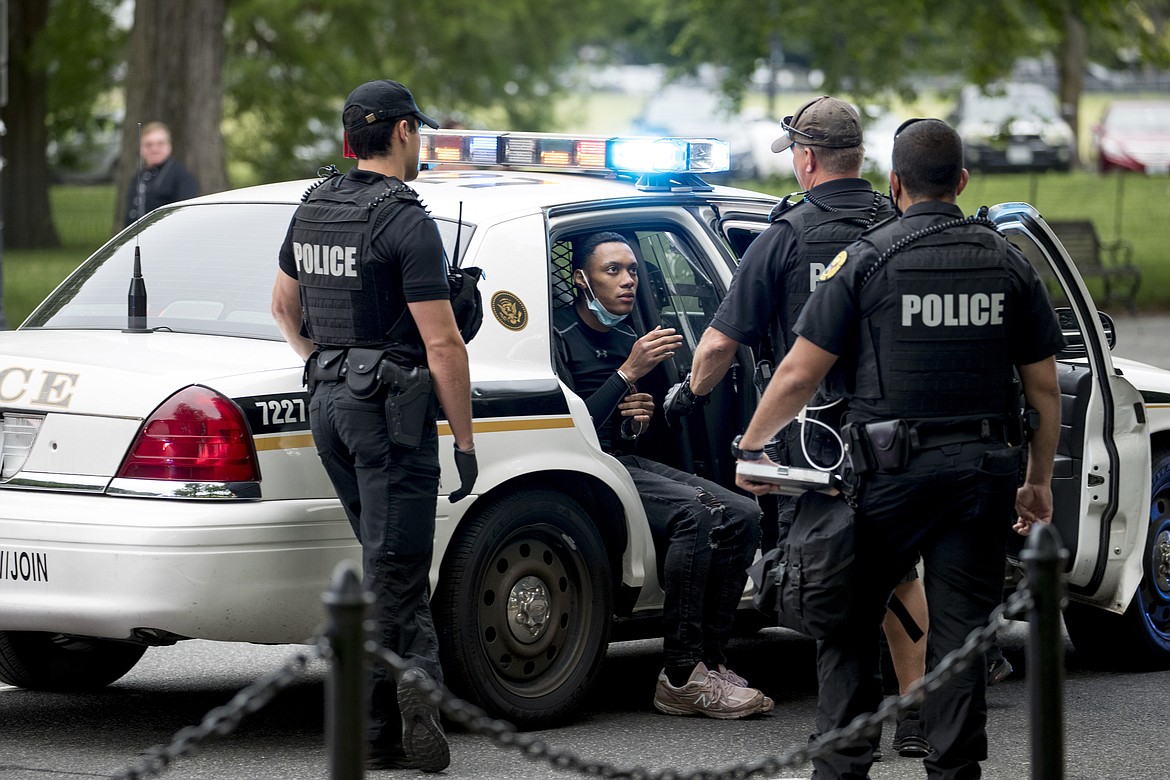 U.S. Secret Service police arrest a man for what one eye witness said an officer told him was for having an imitation gun along Constitution Avenue near the White House in the morning as protests continue over the death of George Floyd in Washington, Tuesday, June 2, 2020. Floyd died after being restrained by Minneapolis police officers. (AP Photo/Andrew Harnik)