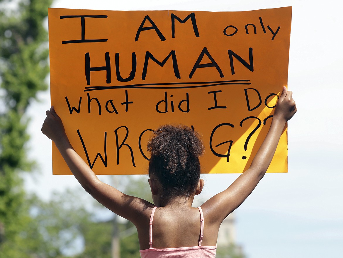 Rylie Blue holds a sign during a Black Lives Matter march and rally Sunday, May 31, 2020, in Oshkosh, Wis. Protests continue across the country over the death of George Floyd, a black man who died after being restrained by Minneapolis police officers on May 25. (William Glasheen/The Post-Crescent via AP)