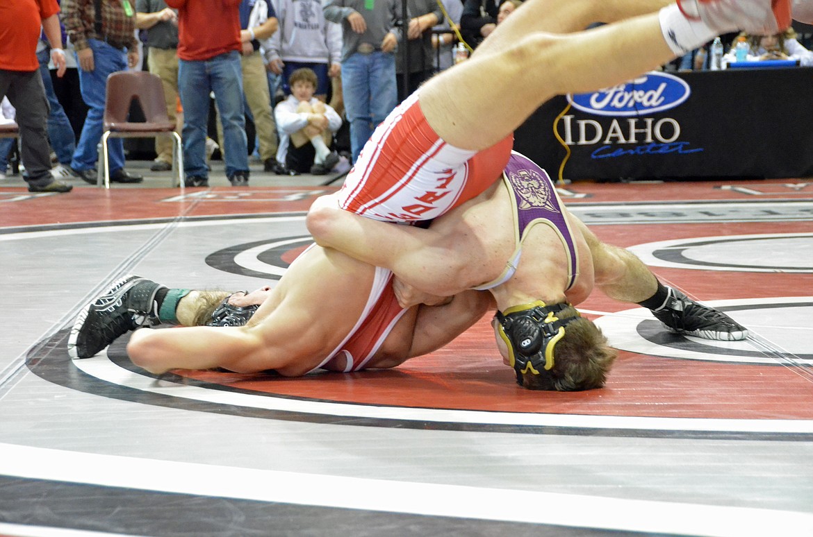 Wildcat wrestler Austin Stepro sets his opponent up for an acrobatic pin during the Idaho State Wrestling Championships. Stepro finished in fifth place in his competitive weight class.