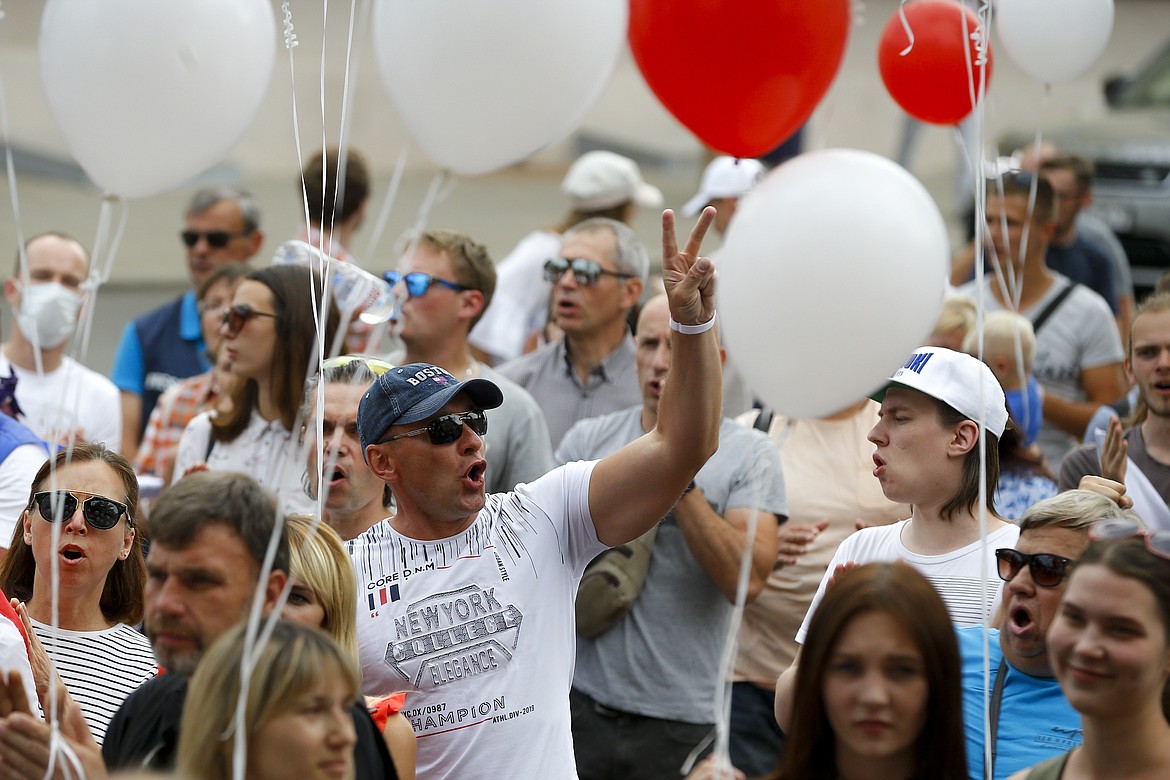 People shout a slogan "release (from prison)" as they gather to show their solidarity with the detainees at a detention center during opposition rally in Minsk, Belarus, Tuesday, Aug. 18, 2020. Top opposition candidate Sviatlana Tsikhanouskaya entered the race after her husband Sergei, a popular opposition blogger, was jailed earlier this year as he tried to rally support for his candidacy. The protesters gathered near a detention center where he is being held and cheered for Sergei on his 42nd birthday on Tuesday. (AP Photo/Sergei Grits)