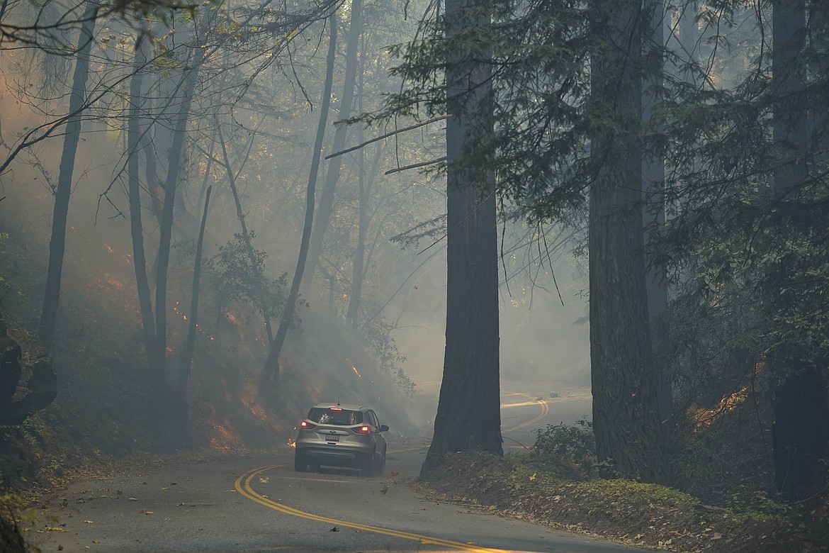 The CZU August Lightning Complex Fire continues to burn Tuesday, Aug. 25, 2020, near Bonny Doon, Calif. (AP Photo/Marcio Jose Sanchez)