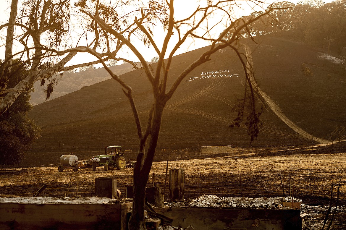 Following the LNU Lightning Complex fires, a sign reading "Vaca Strong" adorns a charred hillside in Vacaville, Calif., on Monday, Aug. 24, 2020. (AP Photo/Noah Berger)