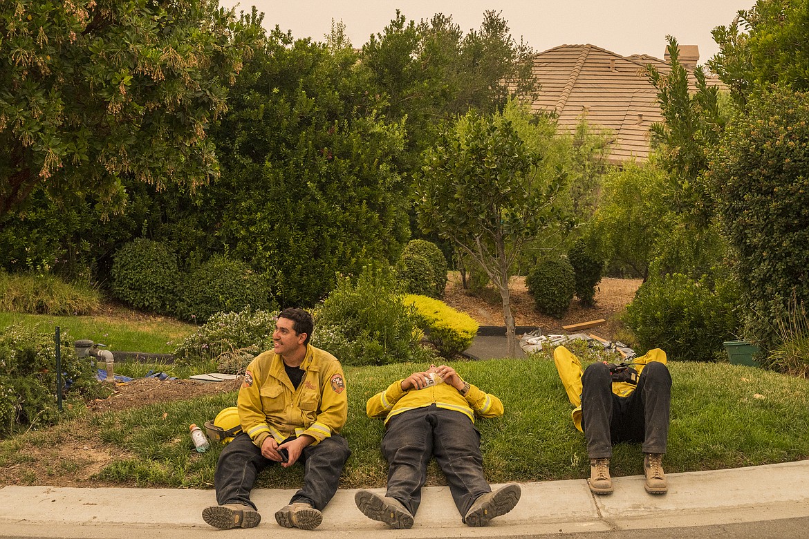 A CalFire crew from Coulterville takes a break while fighting the River Fire near Salinas, Calif., Wednesday, Aug. 19, 2020. (AP Photo/Nic Coury)