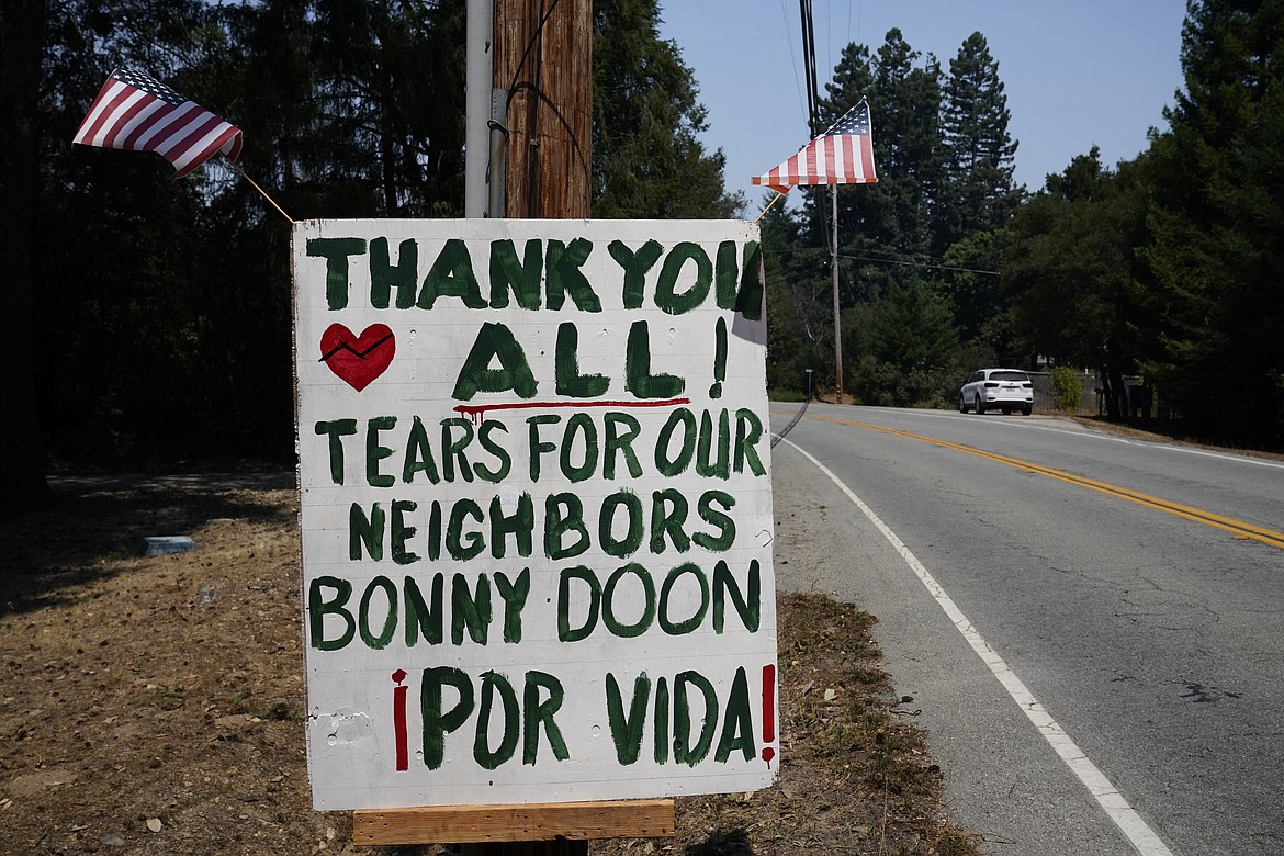 A thank you sign is posted along Empire Grade Rd. Tuesday, Aug. 25, 2020, in Bonny Doon, Calif., after the the CZU August Lightning Complex Fire passed by. (AP Photo/Marcio Jose Sanchez)