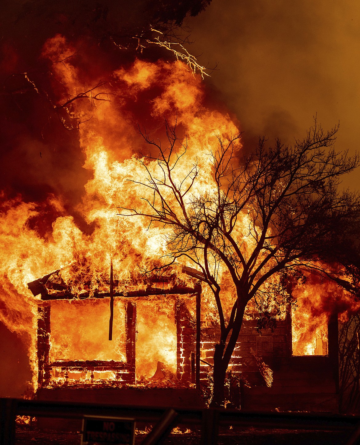 Flames from the LNU Lightning Complex fires consume a home in Vacaville, Calif., Wednesday, Aug. 19, 2020. Fire crews across the region scrambled to contain dozens of wildfires sparked by lightning strikes as a statewide heat wave continues. (AP Photo/Noah Berger)