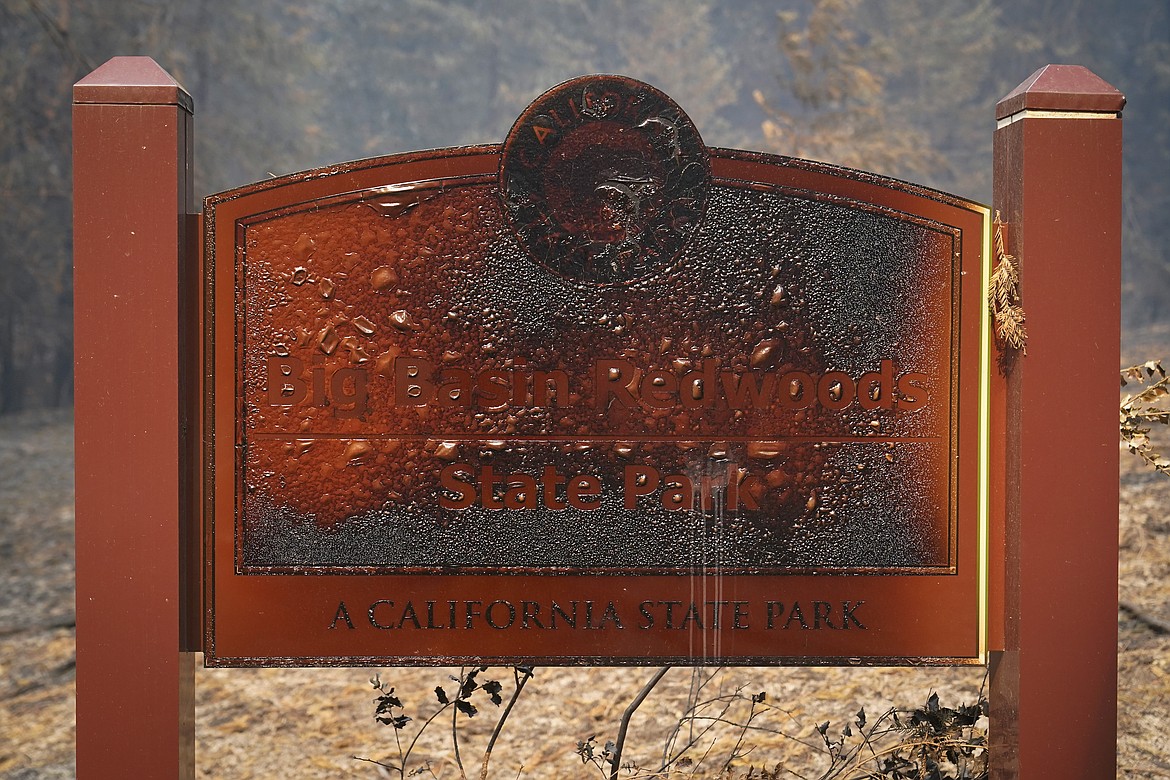 A wildfire-damaged sign welcomes visitors Monday, Aug. 24, 2020, in Big Basin Redwoods State Park, Calif. (AP Photo/Marcio Jose Sanchez)