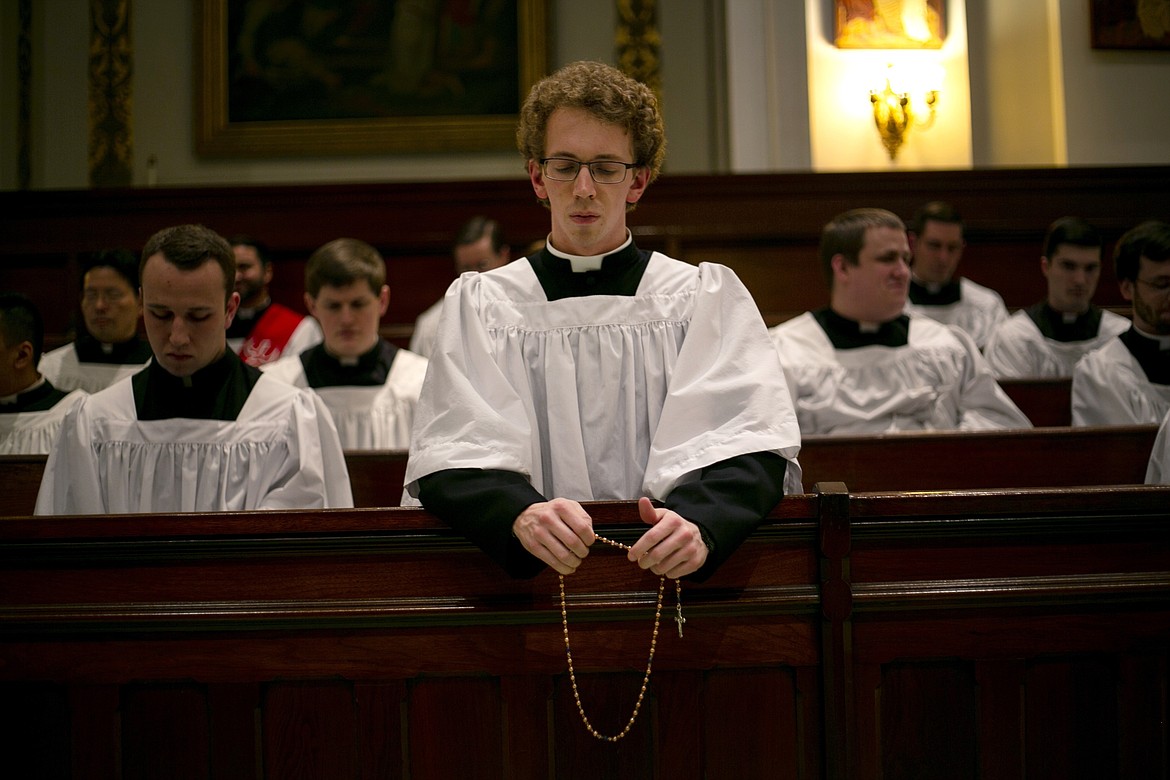 ADVANCE FOR SUNDAY, FEB 16 - Seminarian Jordan Evans prays the rosary in a chapel at St. Charles Borromeo Seminary in Wynnewood, Pa., on Wednesday, Feb. 5, 2020. After scandals in the Catholic Church, future priests say they hope their examples of piety will restore faith in the clergy. (AP Photo/Wong Maye-E)