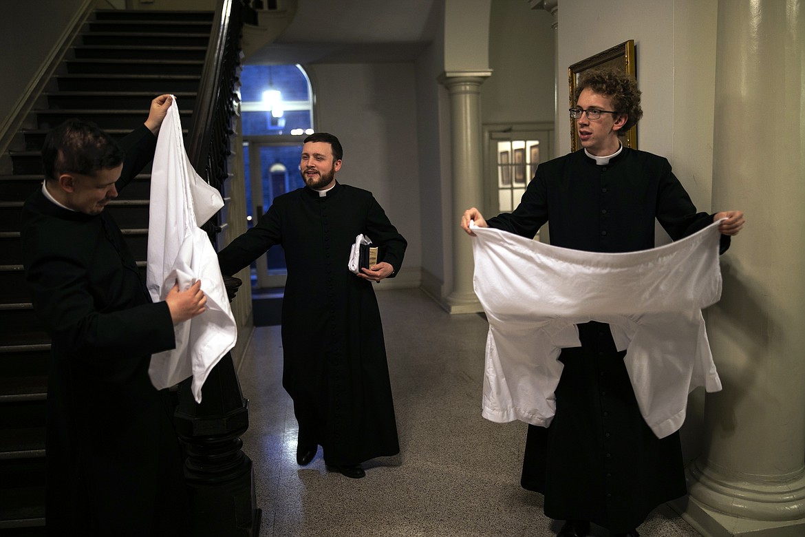 ADVANCE FOR SUNDAY, FEB 16 - Seminarians gather after the conclusion of an afternoon Mass at St. Charles Borromeo Seminary in Wynnewood, Pa., on Wednesday, Feb. 5, 2020. Soaring chapels at the seminary vibrate with blasts of the organ during services. (AP Photo/Wong Maye-E)