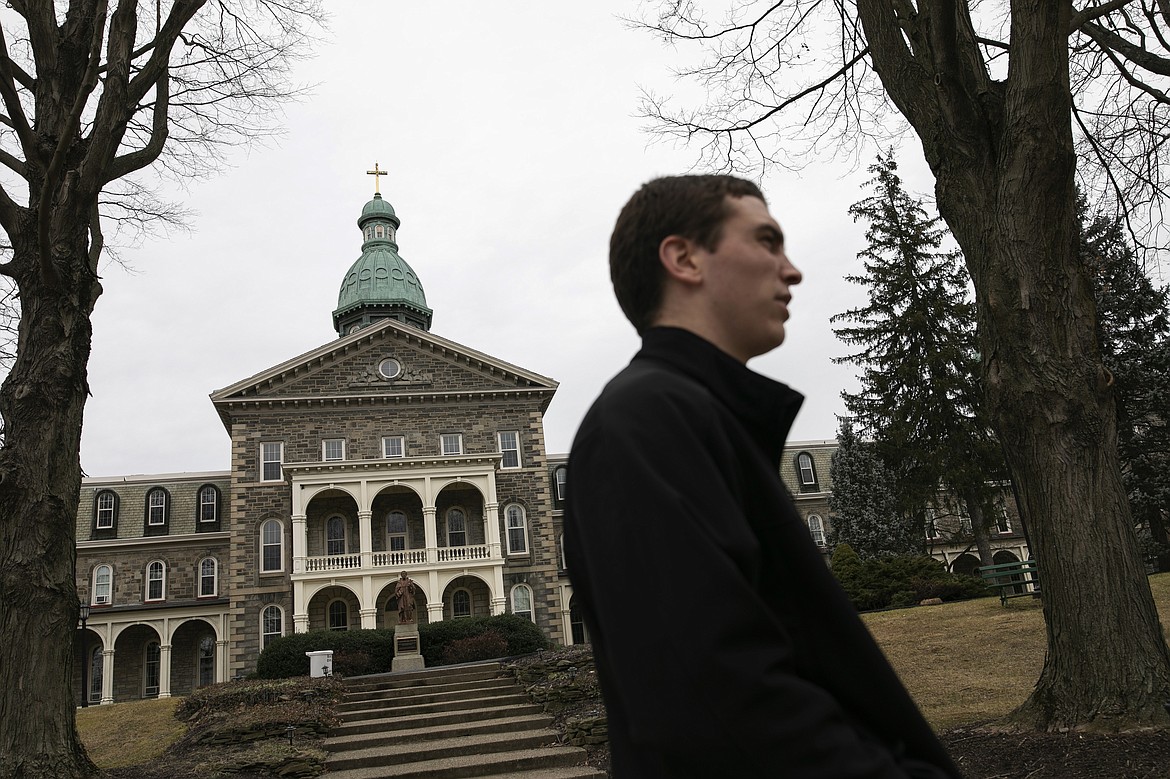 ADVANCE FOR SUNDAY, FEB 16 - Seminarian John Paul Heisler walks the grounds of St. Charles Borromeo Seminary in Wynnewood, Pa., on Wednesday, Feb. 5, 2020. Despite an abuse crisis that has damaged the public's view of Catholic priests, seminarians say they're answering a call from God and hope to help restore faith in the church. (AP Photo/Wong Maye-E)