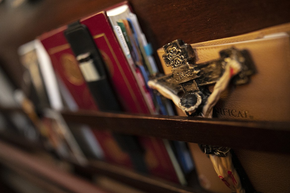 ADVANCE FOR SUNDAY, FEB 16 - A crucifix is set beside books in a pew at St. Charles Borromeo Seminary in Wynnewood, Pa., on Wednesday, Feb. 5, 2020. Soaring chapels at the seminary vibrate with blasts of organs during Mass. (AP Photo/Wong Maye-E)