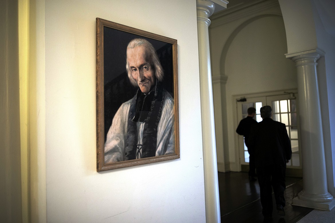 ADVANCE FOR SUNDAY, FEB 16 - A painting of St. John Vianney, patron saint of parish priests, hangs at St. Charles Borromeo Seminary in Wynnewood, Pa., on Wednesday, Feb. 5, 2020. Seminarians say they want to help the Catholic Church move beyond the crises of recent years and restore confidence in priests. (AP Photo/Wong Maye-E)