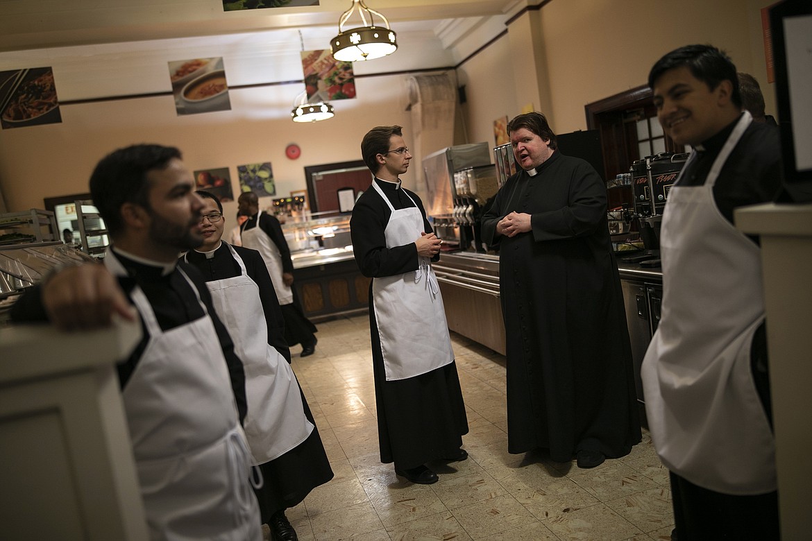 ADVANCE FOR SUNDAY, FEB 16 - Seminarians prepare to serve dinner at St. Charles Borromeo Seminary in Wynnewood, Pa., on Wednesday, Feb. 5, 2020. It is among the seminaries reporting a slight increase in students in recent years despite crises that have rocked the Catholic Church. (AP Photo/Wong Maye-E)