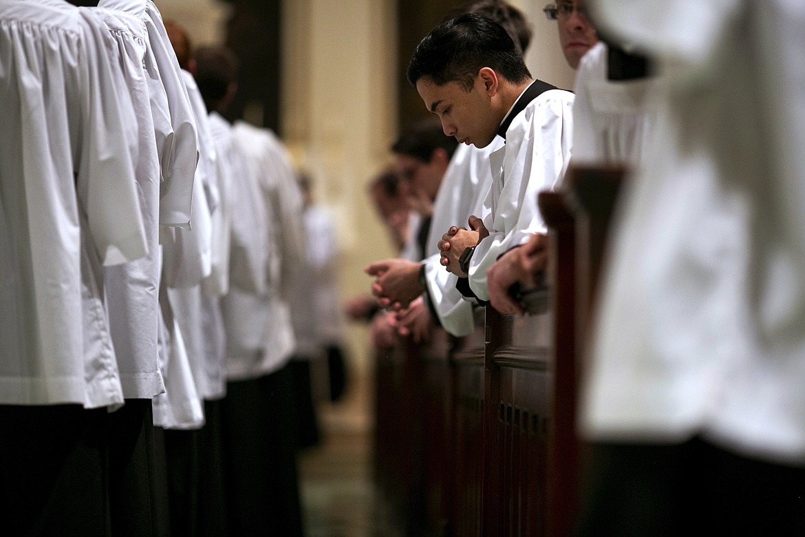 ADVANCE FOR SUNDAY, FEB 16 - Seminarians kneel in prayer at St. Charles Borromeo Seminary in Wynnewood, Pa., on Wednesday, Feb. 5, 2020. Future priests say they hope to help the Catholic Church move beyond the scandals of recent years. (AP Photo/Wong Maye-E)