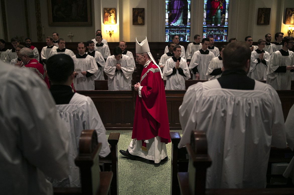 ADVANCE FOR SUNDAY, FEB 16 - Bishop Timothy Senior processes down the aisle at the start of a Mass at St. Charles Borromeo Seminary in Wynnewood, Pa., on Wednesday, Feb. 5, 2020. Senior leads the seminary and says, despite scandals in the Catholic Church, men keep responding to the call to the priesthood. (AP Photo/Wong Maye-E)