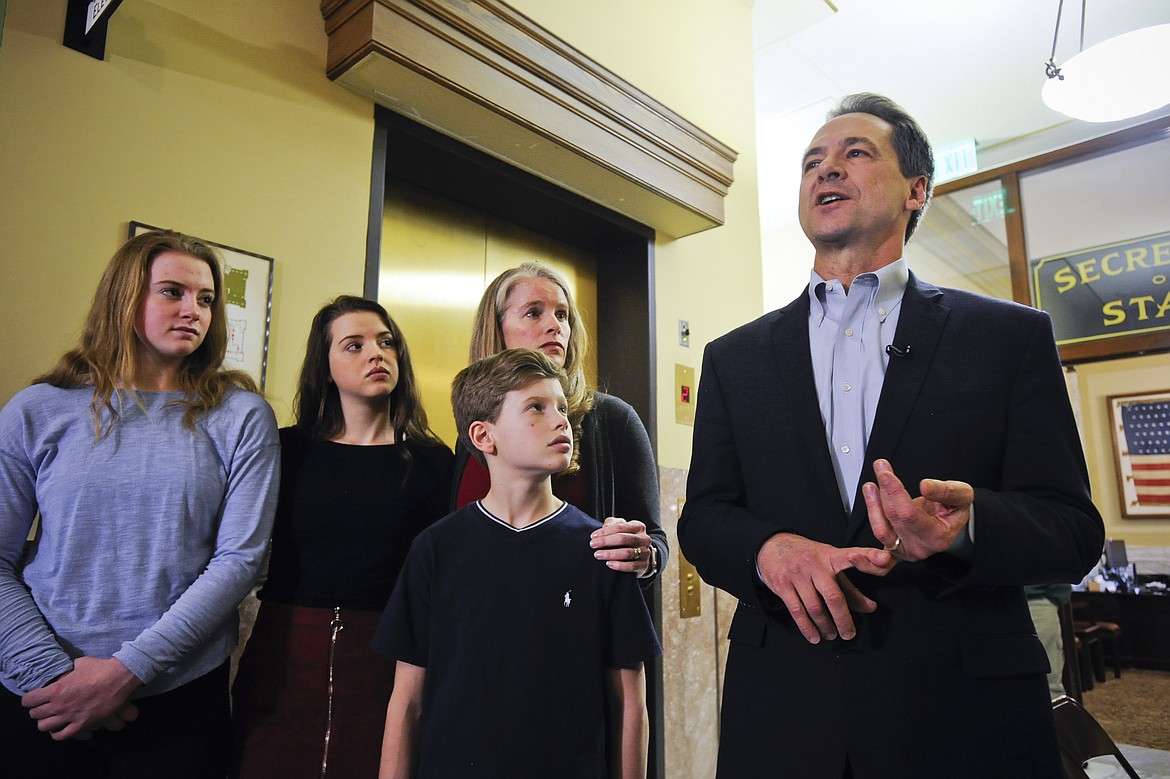FILE - In this Monday, March 9, 2020 file photo with his family by his side, Montana Gov. Steve Bullock speaks to the press after filing paperwork to run for U.S. Senate against incumbent Republican Sen. Steve Daines in Helena, Mont. Bullock has won three state-wide elections but faces a new challenge in trying to unseat a well-financed incumbent. (Thom Bridge/Independent Record via AP,File)