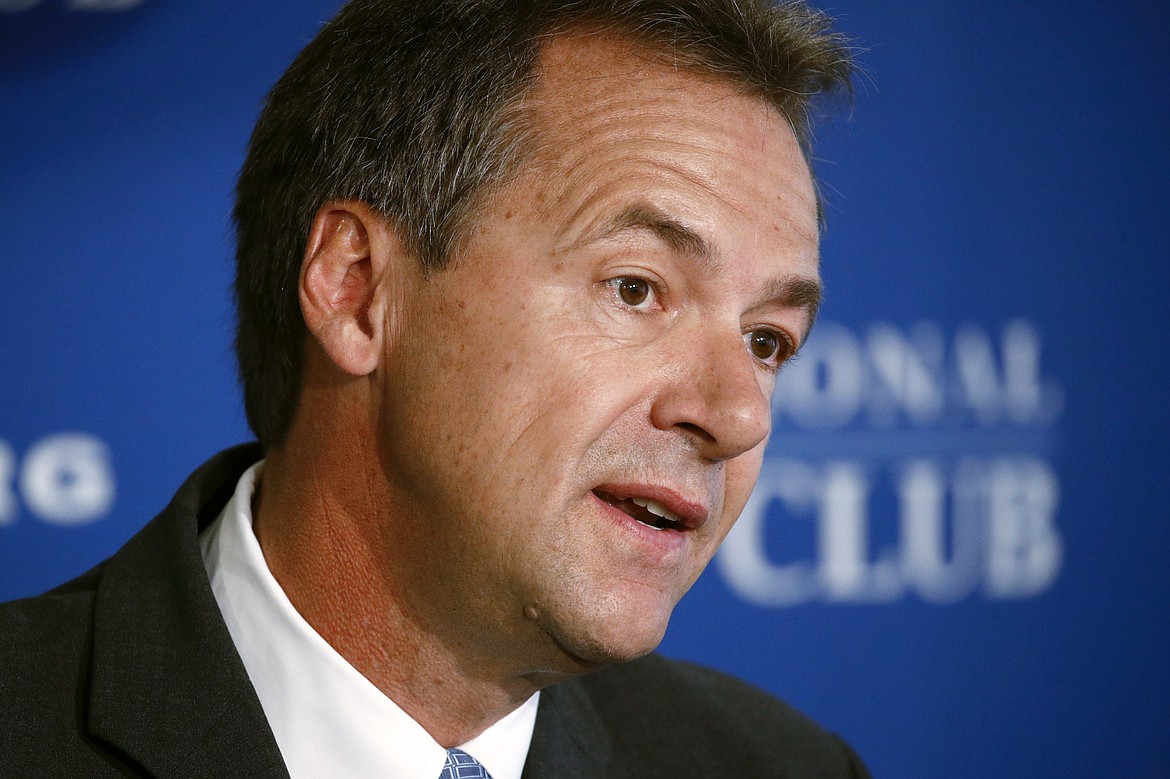 FILE - In this Aug. 7, 2019 file photo, Democratic Montana Gov. Steve Bullock speaks at the National Press Club in Washington.  Bullock was the lame-duck governor of solidly red Montana, fresh off a failed Democratic presidential bid, when he pivoted and announced he’d challenge Republican Sen. Steve Daines for his seat.  But days after he announced his candidacy last month, the coronavirus claimed its first cases in Montana. That shifted the spotlight onto Bullock as he leads the state’s pandemic response, leaving Daines in the unusual position of a sitting senator competing for attention.  (AP Photo/Patrick Semansky, File)