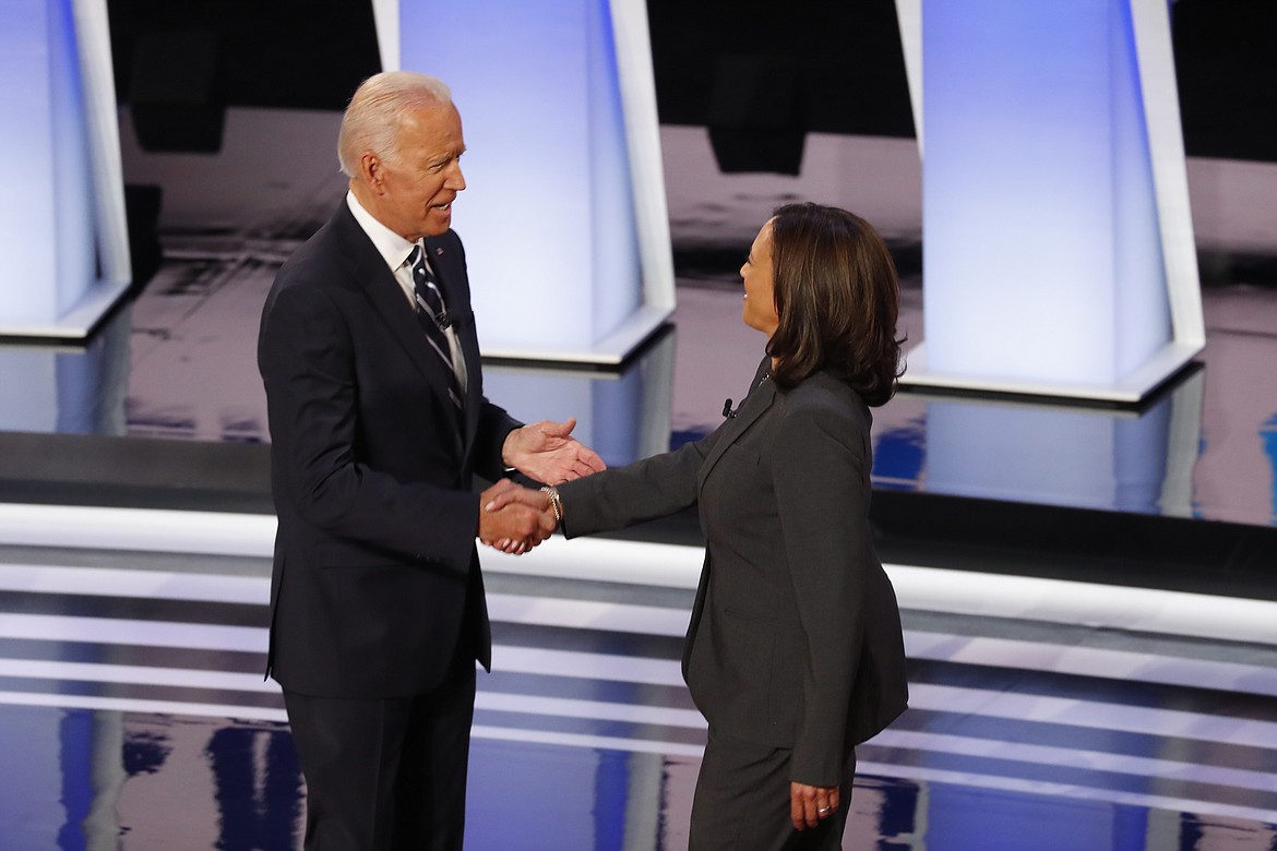 FILE - In this July 31, 2019, file photo, fFormer Vice President Joe Biden shakes hands with Sen. Kamala Harris, D-Calif., before the second of two Democratic presidential primary debates at the Fox Theatre in Detroit. Democratic presidential candidate former Vice President Joe Biden has chosen  Harris as his running mate. (AP Photo/Paul Sancya, File)