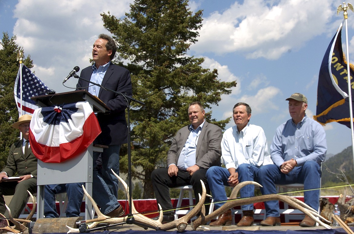 In this Aug. 17, 2017 file photo, Montana Gov. Steve Bullock, Sen. Jon Tester (D-Mont.), Sen. Steve Daines (R-Mont.) and Rep. Greg Gianforte (R-Mont.) are seen at an event marking a conservation agreement at a former mining site in Jardine, Mont. Steve Bullock never got to square off directly against President Donald Trump before dropping out of the Democratic presidential primary race last year. But the two-term governor is getting another chance on his home turf by trying to oust a strong Trump ally, first-term Republican Sen. Steve Daines in Montana's U.S. Senate race. (AP Photo/Matthew Brown)