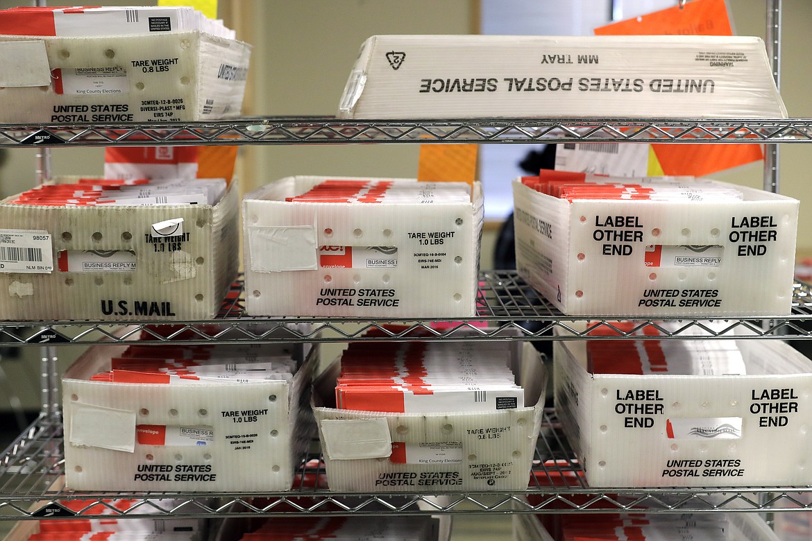 FILE - In this Aug. 5, 2020, file photo vote-by-mail ballots are shown in U.S. Postal service sorting trays the King County Elections headquarters in Renton, Wash., south of Seattle. The U.S. Postal Service has sent letters to 46 states and the District of Columbia, warning it cannot guarantee all ballots cast by mail for the November election will arrive in time to be counted, The Washington Post reported Friday, Aug. 14. (AP Photo/Ted S. Warren, File)