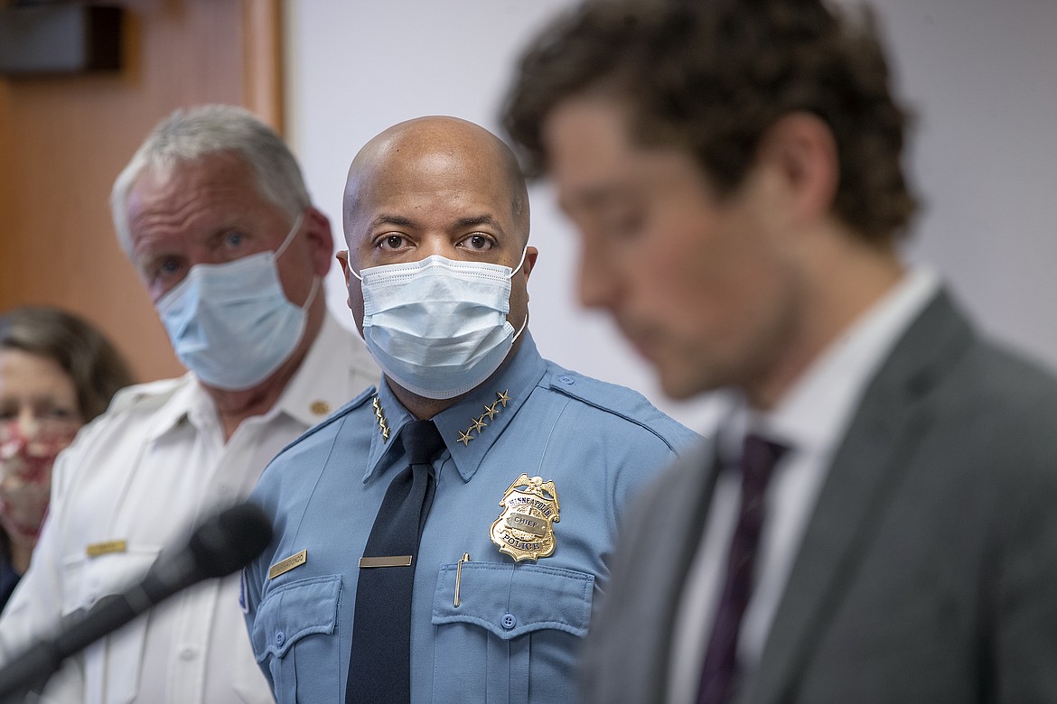 FILE - In this May 28, 2020, file photo, Minneapolis Police Chief Medaria Arradondo, center, listens as Minneapolis Mayor Jacob Frey becomes emotional during a news conference in Minneapolis, Minn. George Floyd’s death and the protests it ignited nationwide over racial injustice and police brutality have raised questions about whether Arradondo — or any chief — can fix a department that's now facing a civil rights investigation. (Elizabeth Flores/Star Tribune via AP, File)