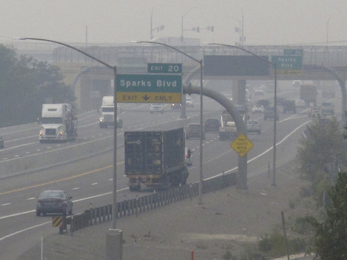 Dense smoke from California wildfires up to 200 miles away obscures the view of traffic traveling on Interstate 80, looking west in Sparks, Nev., Wednesday, Aug. 19, 2020. Local schools canceled all outdoor activities as the air quality index approached the "very unhealthy" category for the general population Wednesday afternoon. (AP Photo/Scott Sonner)