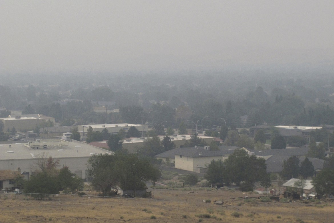 Smoke from California wildfires up to 200 miles away blankets a residential neighborhood in Sparks, Nev., Wednesday, Aug. 19, 2020. Local schools canceled all outdoor activities as the air quality index approached the "very unhealthy" category for the general population Wednesday afternoon. (AP Photo/Scott Sonner)