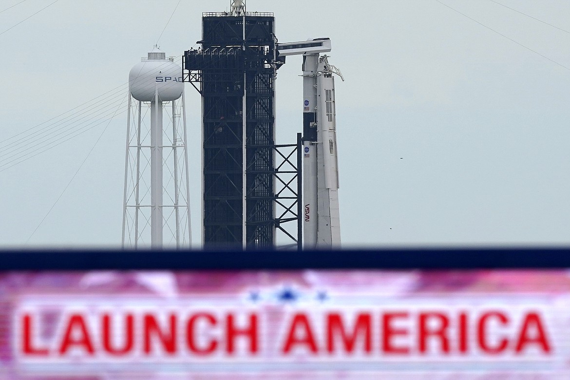 The SpaceX Falcon 9, with the Crew Dragon spacecraft on top of the rocket, sits on Launch Pad 39-A, Tuesday, May 26, 2020, at Kennedy Space Center in Cape Canaveral, Fla. Two astronauts will fly on the SpaceX Demo-2 mission to the International Space Station scheduled for launch on May 27. (AP Photo/David J. Phillip)