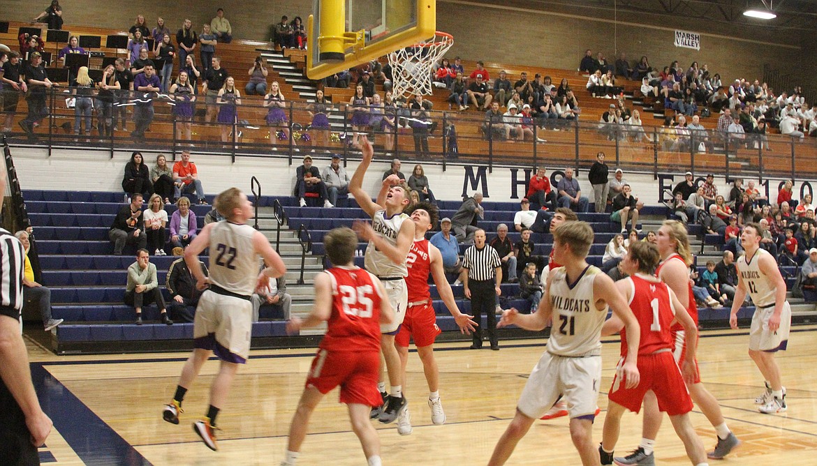 Above: Kellogg’s Taylor Bush finishes a lay-in during a decisive third quarter run for the Wildcats during their 56-48 win over Homedale at the 3A State Tournament.
Right: Kellogg’s Gavin Luna scrambles for a loose ball during the Wildcats’ game against Sugar Salem.