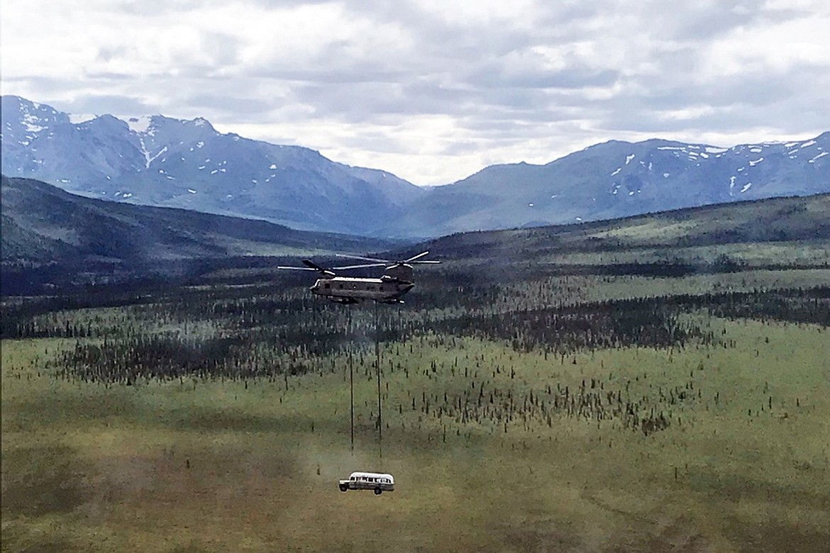 In this photo released by the Alaska National Guard, Alaska Army National Guard soldiers use a CH-47 Chinook helicopter to airlift an abandoned bus, popularized by the book and movie "Into the Wild," out of its location in the Alaska backcountry in light of public safety concerns, as part of a training mission Thursday, June 18, 2020. Alaska Natural Resources Commissioner Corri Feige, in a release, said the bus will be kept in a secure location while her department weighs various options for what to do with it. (Sgt. Seth LaCount/Alaska National Guard via AP)