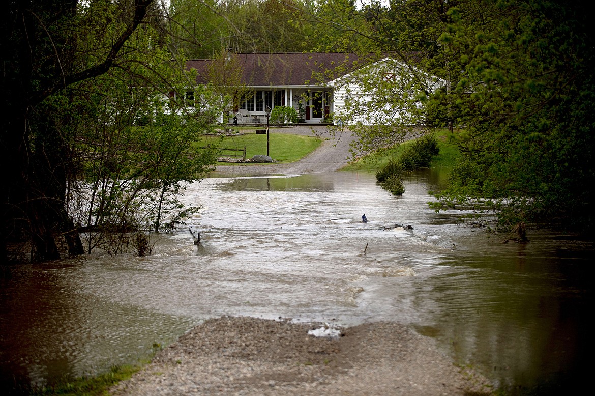 Water engulfs a Swan Township driveway at the intersection of Trimm and Roosevelt roads as heavy rains flood Saginaw County, Mich., on Tuesday, May 19, 2020. (Jake May/The Flint Journal via AP)