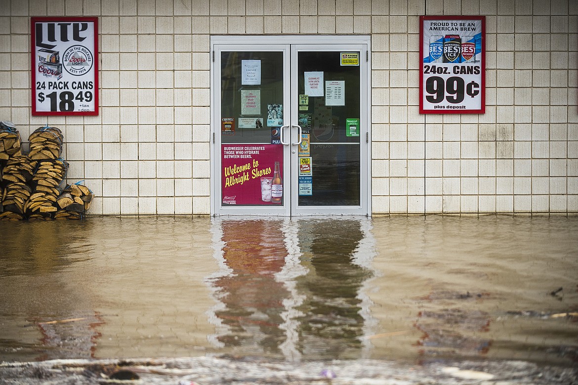 Floodwater surrounds Wixom Lake Gas & Launch, Tuesday, May 19, 2020 along the Tittabawassee River in Beaverton, Mich. An evacuation order was released the night before for residents of Sanford and Wixom Lakes, warning of "imminent dam failure." (Katy Kildee/Midland Daily News via AP)