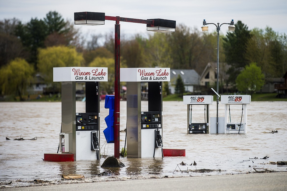 Floodwater surrounds gas pumps at Wixom Lake Gas & Launch Tuesday, May 19, 2020, along the Tittabawassee River in Beaverton, Mich. (Katy Kildee/Midland Daily News via AP)