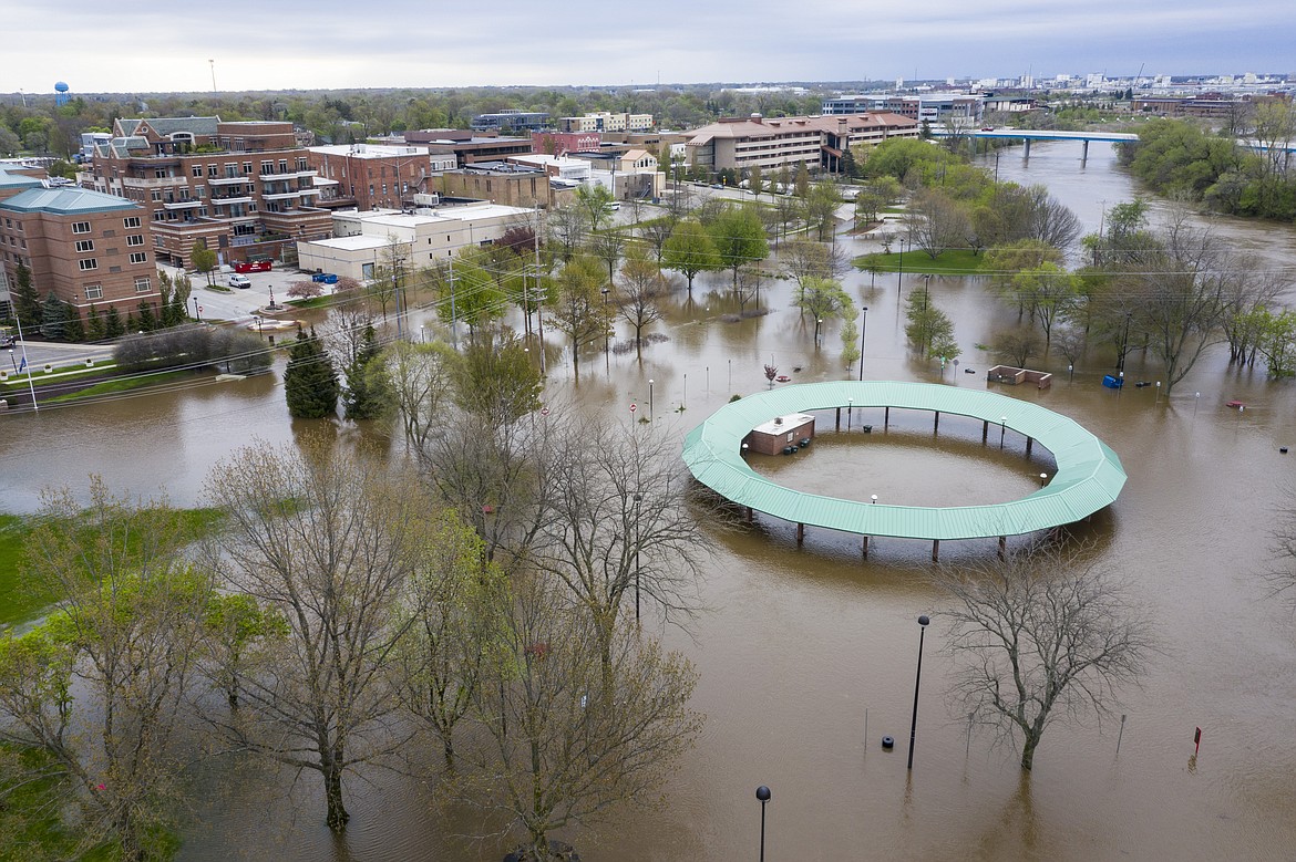 Water floods the Midland Area Farmers Market and the bridge along the Tittabawassee River in Midland, Mich. on Tuesday, May 19, 2020. (Kaytie Boomer/MLive.com/The Bay City Times via AP)
