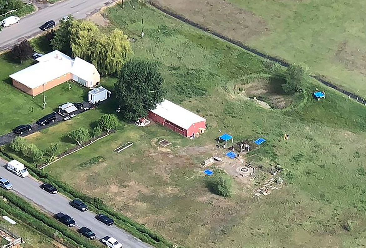 CORRECTS LOCATION TO SALEM, IDAHO, INSTEAD OF REXBURG  This aerial photo provided by East Idaho News shows authorities investigating a home in Salem, Idaho, on Tuesday June 9, 2020. Authorities say they uncovered human remains at an Idaho man's home as they investigated the disappearance of his new wife's two children. The case has drawn global attention for its ties to the couple's doomsday beliefs and the mysterious deaths of their former spouses. Police in the small town say Chad Daybell was taken into custody. (Nate Eaton/EastIdahoNews.com via AP)