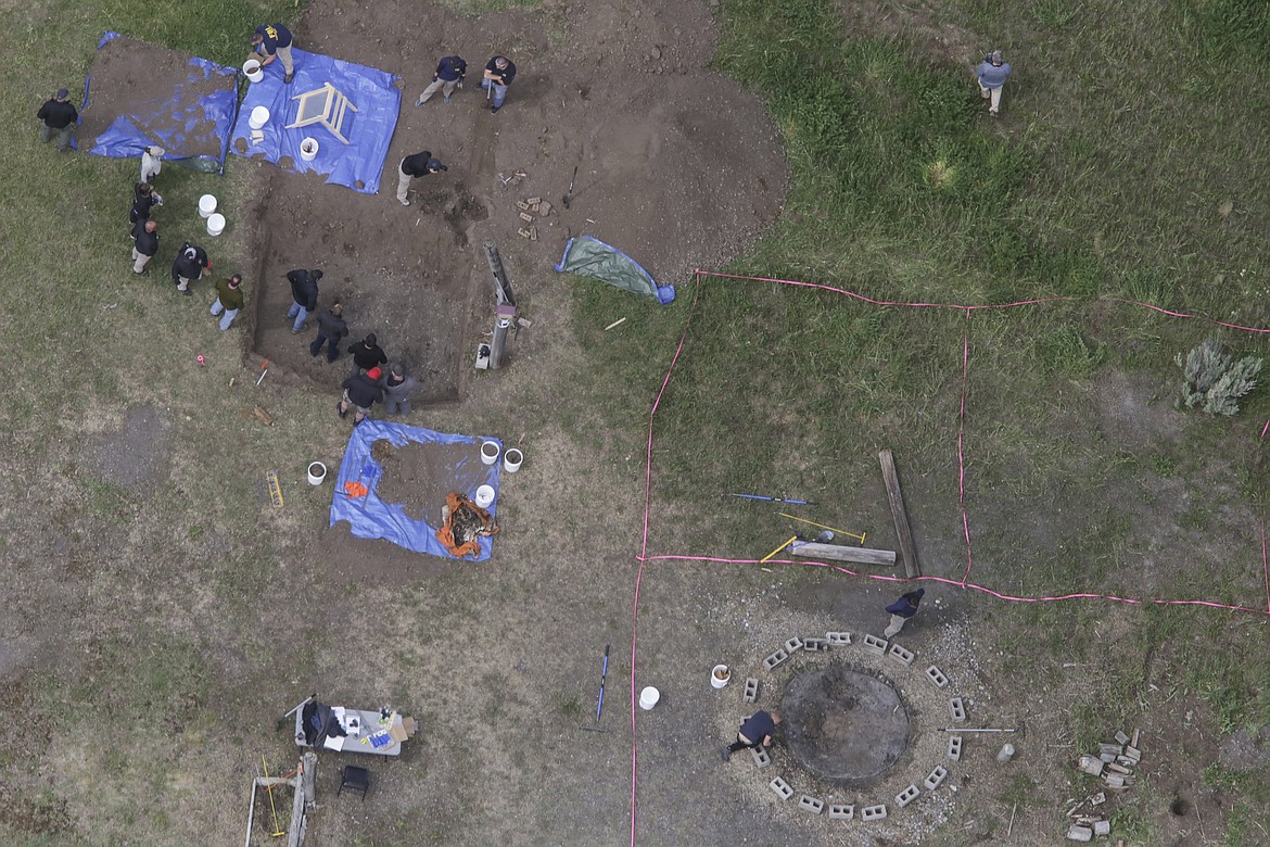 In this aerial photo, investigators search for human remains at Chad Daybell's residence in the 200 block of 1900 East, Tuesday, June 9, 2020, in Salem, Idaho. Authorities say they uncovered human remains at Daybell's home as they investigated the disappearance of his new wife’s two children. Police in the small town of Rexburg say Daybell was taken into custody Tuesday. He had recently married the children’s mother, Lori Vallow Daybell, who has been charged with child abandonment. (John Roark/The Idaho Post-Register via AP)
