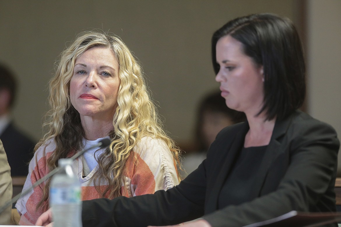 FILE - In this March 6, 2020, file photo, Lori Vallow Daybell glances at the camera during her hearing, with her defense attorney, Edwina Elcox, right, in Rexburg, Idaho. An Idaho prosecutor is expected Monday, Aug. 3, 2020, to begin sketching out his case against an Idaho couple at the center of a bizarre missing children's case that ended in tragedy when their bodies were found buried on a rural eastern Idaho property earlier this year. Chad Daybell married the kids' mom, Lori Daybell, late last year, and she's charged with conspiring to help keep the bodies hidden. Both Daybells have pleaded not guilty. (John Roark/The Idaho Post-Register via AP, Pool, File)