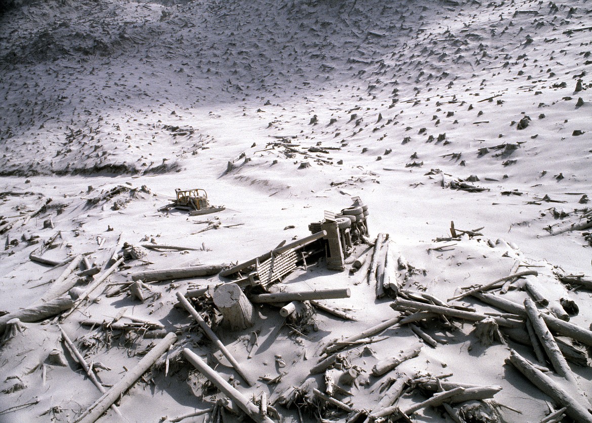 FILE - In this May 20, 1980, file photo, a wrecked logging truck and crawler tractor are shown amidst ash and downed trees near Mount St. Helens two days after the volcano erupted in Washington State. May 18, 2020, is the 40th anniversary of the eruption. (AP Photo/File)