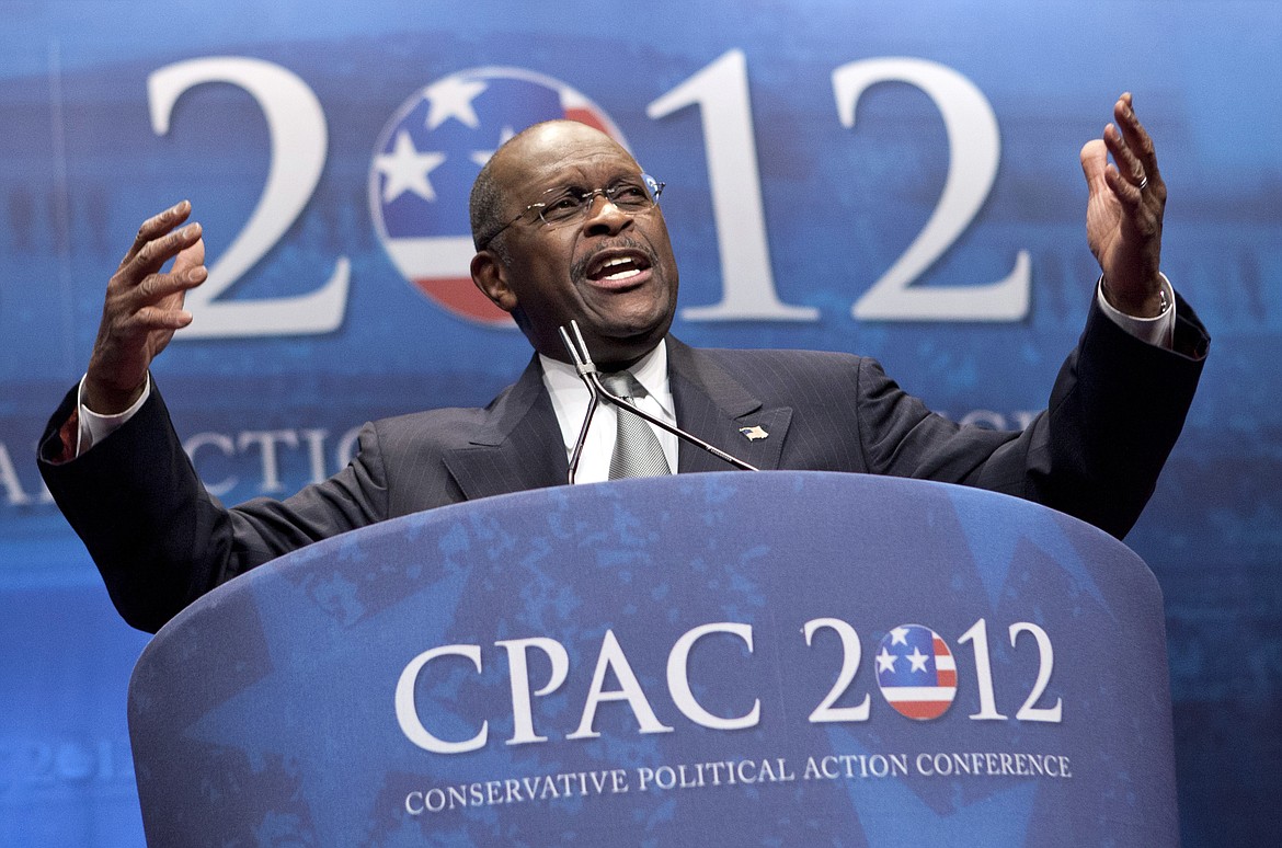 FILE - In this Feb. 9, 2012 file photo, former presidential candidate Herman Cain addresses the Conservative Political Action Conference in Washington.  Cain has died after battling the coronavirus. A post on Cain's Twitter account on Thursday, July 30, 2020 announced the death.   (AP Photo/J. Scott Applewhite, File)