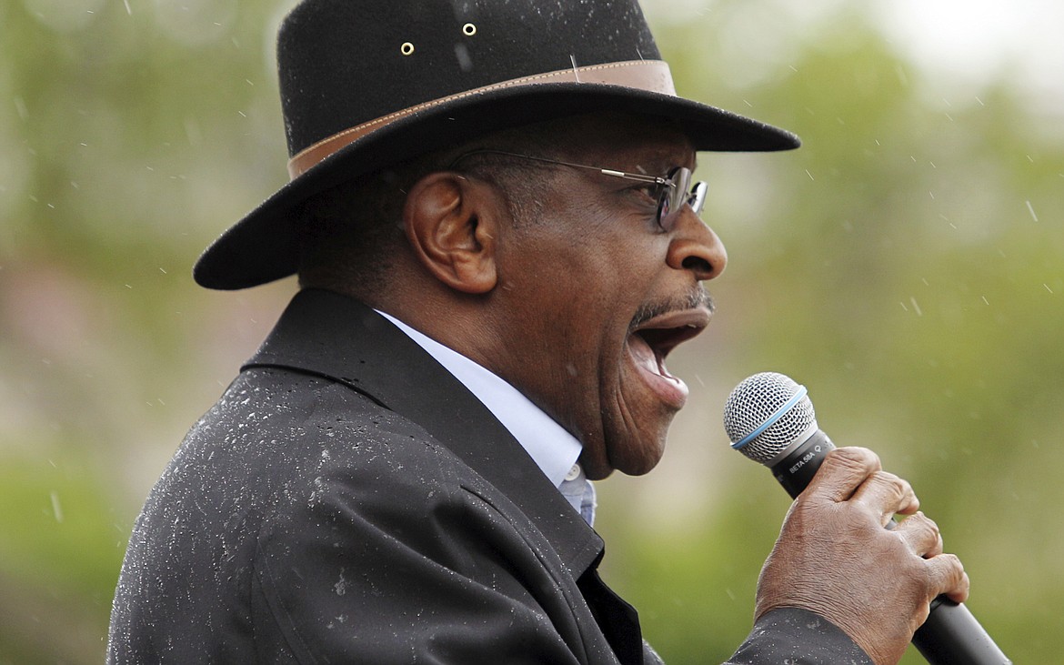 FILE - In this April 28, 2012 file photo, former Republican presidential candidate Herman Cain speaks during the annual Tax Cut Rally, sponsored by the Taxpayers League of Minnesota, at the Minnesota State Capitol in St. Paul, Minn.  Cain has died after battling the coronavirus. A post on Cain's Twitter account on Thursday, July 30, 2020 announced the death. (AP Photo/Genevieve Ross, File)