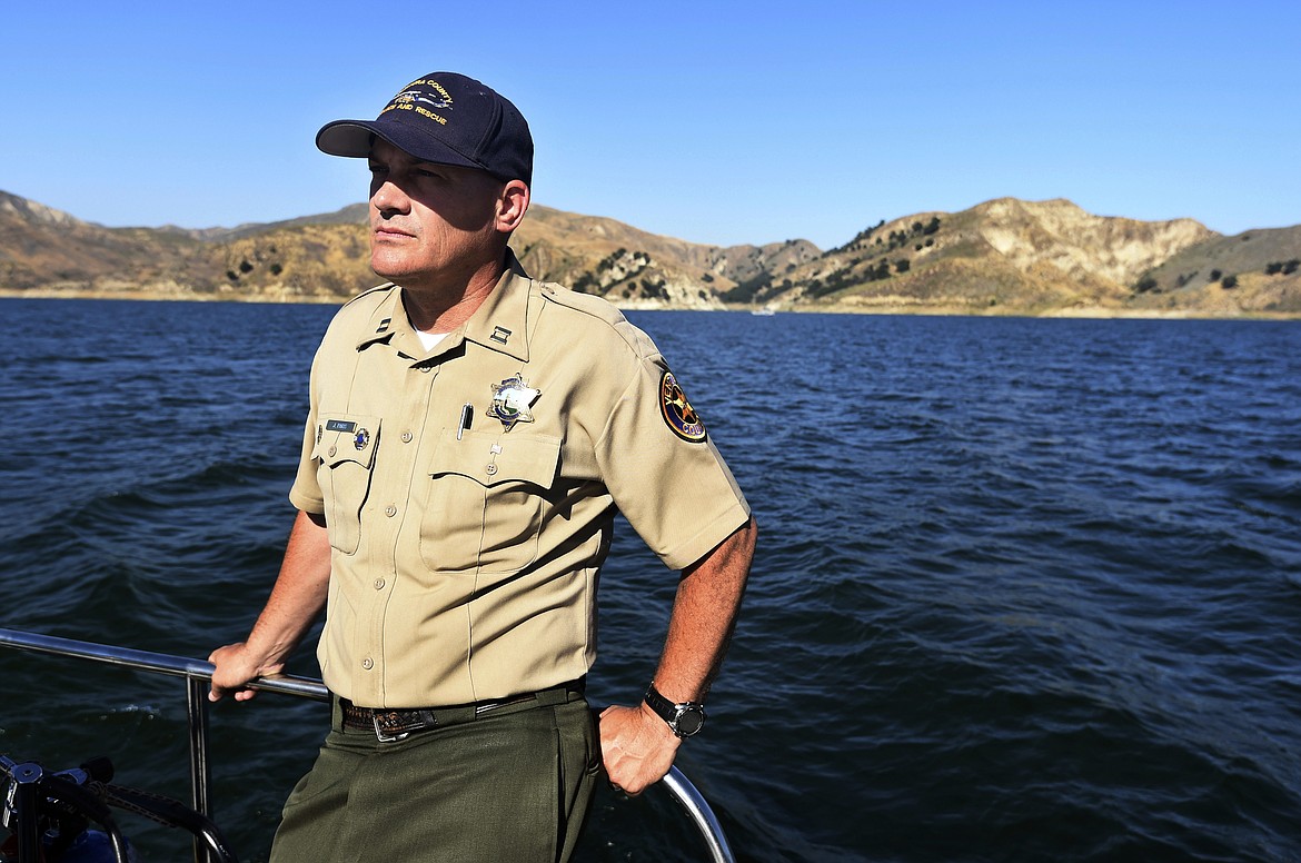 Capt. Jeremy Paris of the search and rescue unit of the Ventura County Sheriff's Department continues the search for missing actress Naya Rivera at Lake Piru, Friday, July 10, 2020, in Los Padres National Forest, Calif., about 55 miles (90 kilometers) northwest of Los Angeles. Authorities said that they believe the "Glee" star drowned in the lake Wednesday, but they are continuing the search for her two days after her 4-year-old son was found alone in a rented boat. (AP Photo/Chris Pizzello)