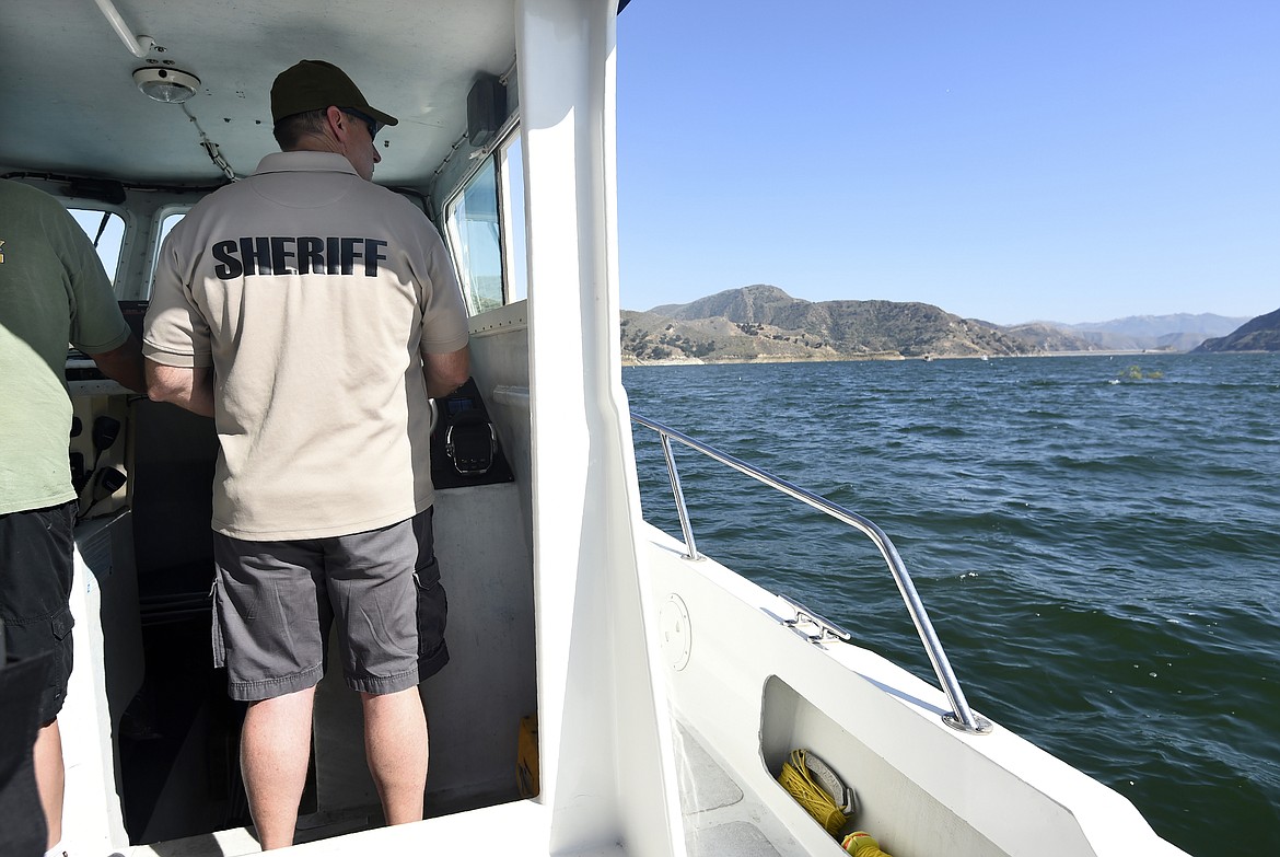 Sgt. Carl Patterson, of the Ventura County Sheriff's Department, continues the search for missing actress Naya Rivera at Lake Piru, Friday, July 10, 2020, in Los Padres National Forest, Calif., about 55 miles (90 kilometers) northwest of Los Angeles. Authorities said that they believe the "Glee" star drowned in the lake Wednesday, but they are continuing the search for her two days after her 4-year-old son was found alone in a rented boat. (AP Photo/Chris Pizzello)