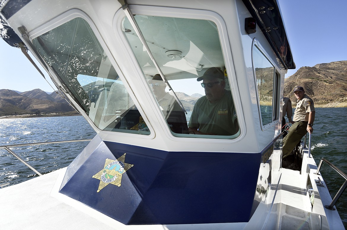 Ventura County Sheriff's Department Senior Deputy Larry Hanson, second from right, and Capt. Jeremy Paris, far right, continue the search for missing actress Naya Rivera at Lake Piru, Friday, July 10, 2020, in Los Padres National Forest, Calif., about 55 miles (90 kilometers) northwest of Los Angeles. Authorities said that they believe the "Glee" star drowned in the lake Wednesday, but they are continuing the search for her two days after her 4-year-old son was found alone in a rented boat. (AP Photo/Chris Pizzello)