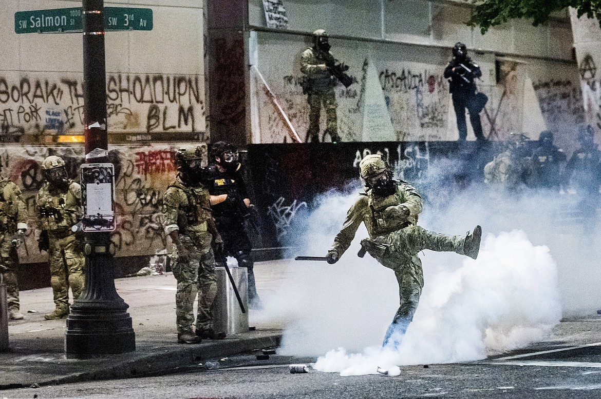 Federal officers use crowd control munitions to disperse Black Lives Matter protesters outside the Mark O. Hatfield United States Courthouse in Portland, Ore. on July 21, 2020. (AP Photo/Noah Berger)