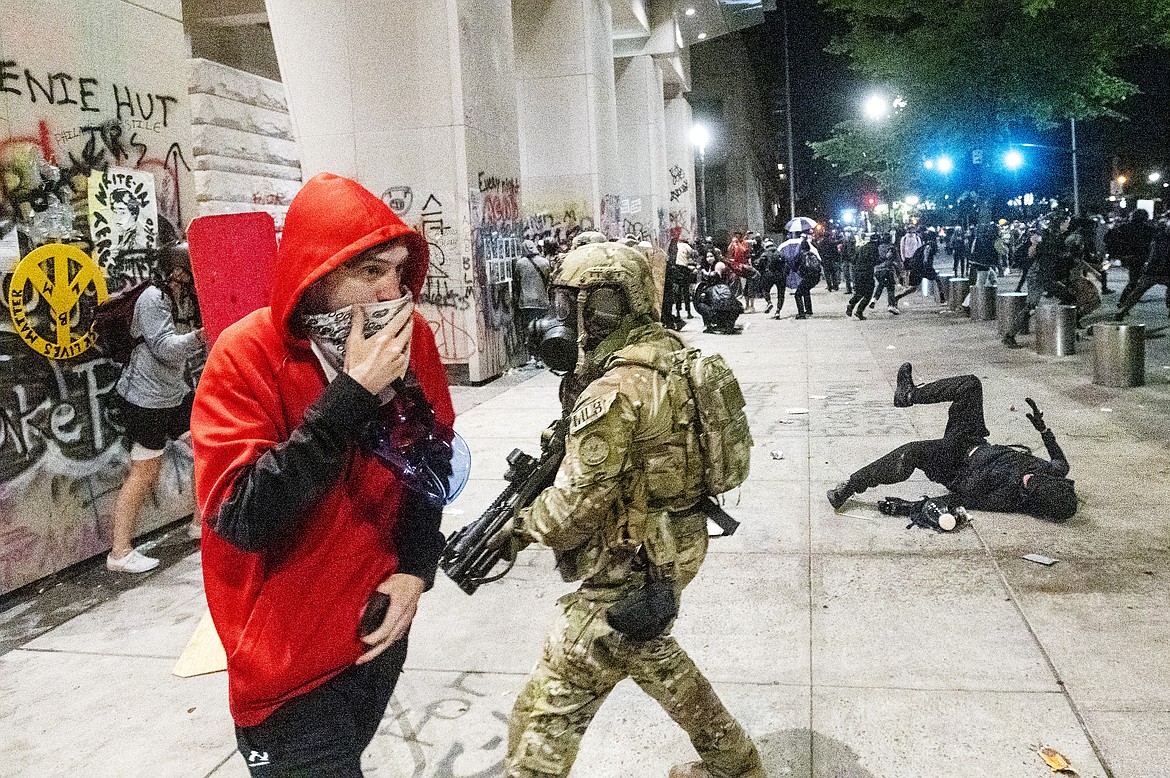 Federal officers disperse Black Lives Matter protesters outside the Mark O. Hatfield United States Courthouse in Portland, Ore. on July 22, 2020. (AP Photo/Noah Berger)