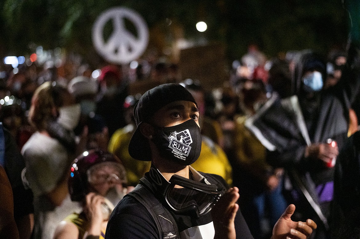 A Black Lives Matter protester rallies with others outside the Mark O. Hatfield United States Courthouse in Portland, Ore. on July 19, 2020.  (AP Photo/Noah Berger)