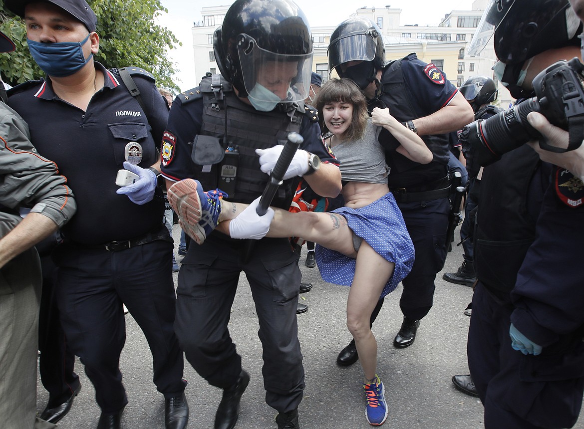 Police detain a woman protesting against the court verdict for Yuliy Boyarshinov and Viktor Filinkov, members of the left-wing youth group Set (Network) at the Western regional military court in St. Petersburg, Russia, Monday, June 22, 2020. A Russian military court convicted the two members of the group of terrorism and sentenced them to prison terms of five and a half and seven years, in a case that human rights groups called fabricated and based on coerced testimony. (AP Photo/Dmitri Lovetsky)