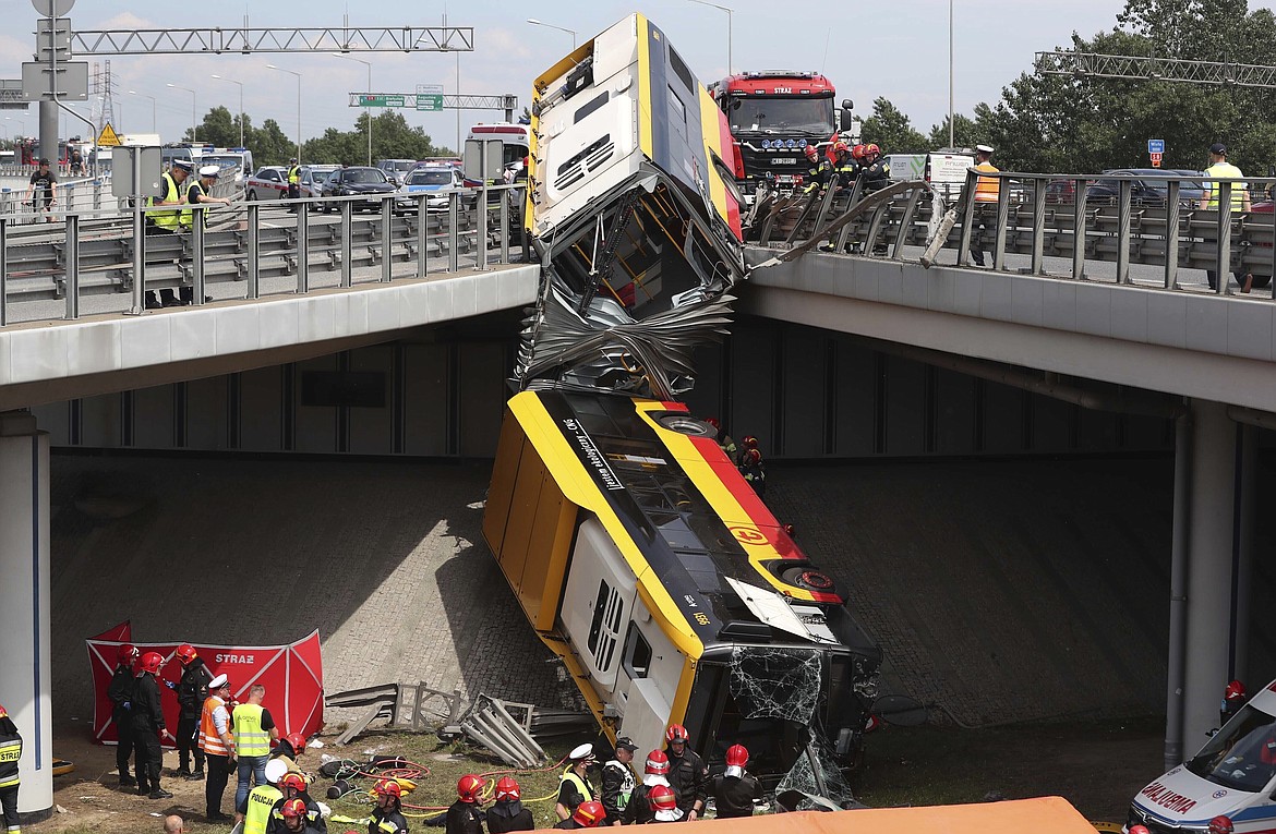 The wreckage of an articulated city bus hangs off an overpass after a fatal accident in Warsaw, Poland, on June 25, 2020. The accident forced Warsaw Mayor Rafal Trzaskowski, who is a runner-up candidate in Sunday's presidential election, to suspend his campaigning. (AP Photo/Czarek Sokolowski)