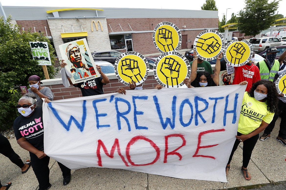 Protesters rally outside a McDonald's in Detroit, Monday, July 20, 2020. The national workers strike saw people walk off the job Monday in U.S. cities to protest systemic racism and economic inequality. (AP Photo/Paul Sancya)