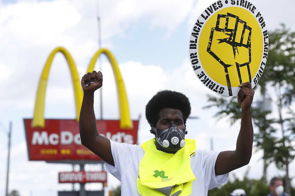 Jerry Johnson takes part in a protester rally outside a McDonald's in Detroit, Monday, July 20, 2020. The national workers strike , dubbed  the “Strike for Black Lives,” saw people walk off the job Monday in U.S. cities to protest systemic racism and economic inequality. (AP Photo/Paul Sancya)