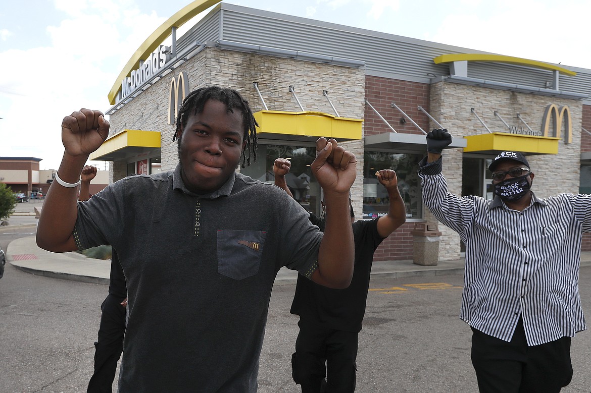 Lavell Bates leads co-workers from work to a protester rally outside a McDonald's in Detroit, Monday, July 20, 2020.  (AP Photo/Paul Sancya)